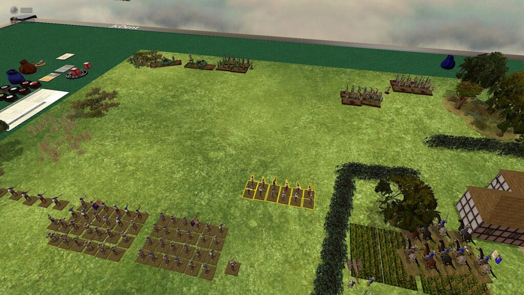 A green TTS table and a green grass-texture board. It has some clumps of trees and shrubs. There's a yard surrounded by hedgerows to the right. An army is arrayed at the bottom of the picture, blocks of men mounted on squares. The yard hosts a cavalry unit and a cannon. 

On the opposite edge of the table, blocks of infantry and two cannons. 